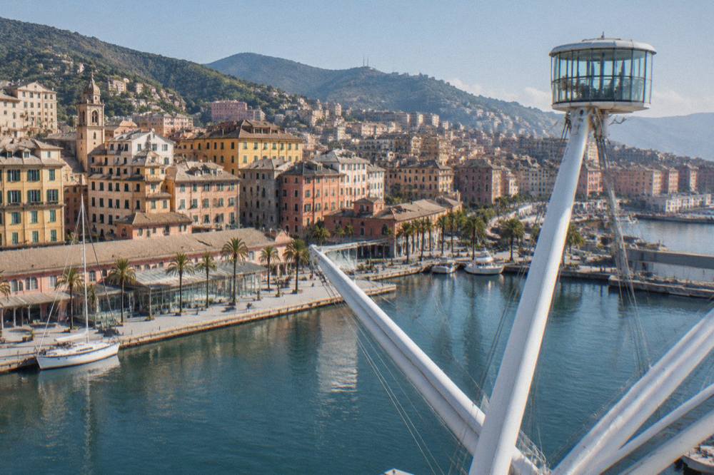Waterfront promenade of the Porto Antico in Genoa on a bright morning with the Bigo lift structure