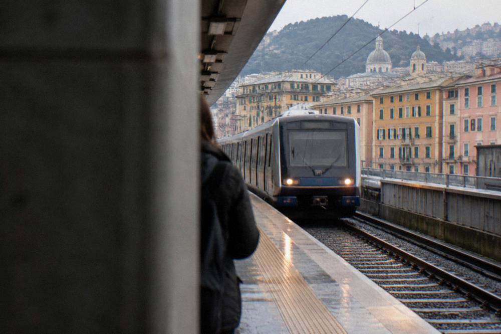 Metro station platform in Genoa with a train arriving