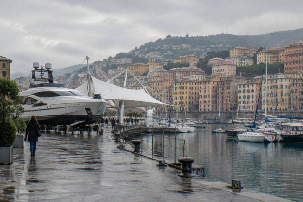 A large motor yacht displayed onshore at a boat show next to the harbour