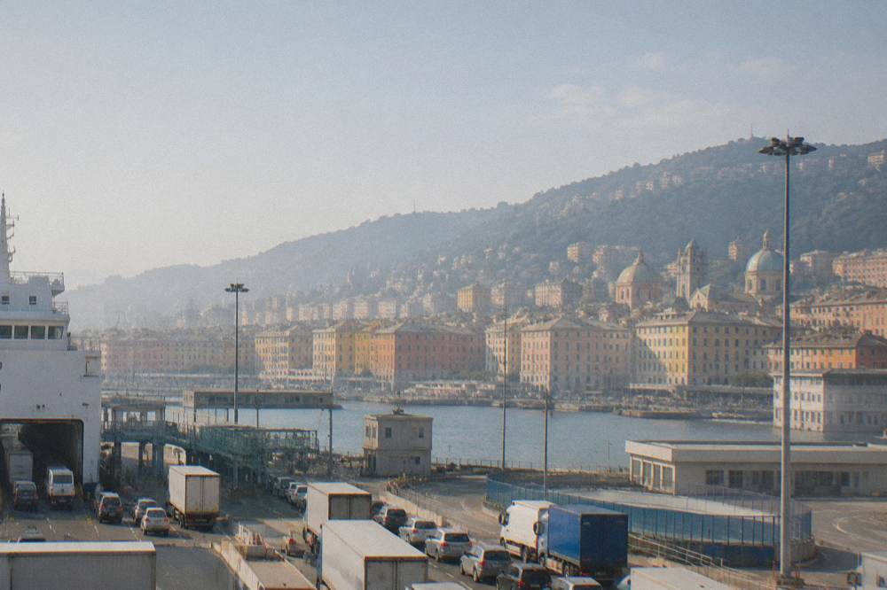 Trucks and cars queued in ferry boarding lanes inside the Genoa port