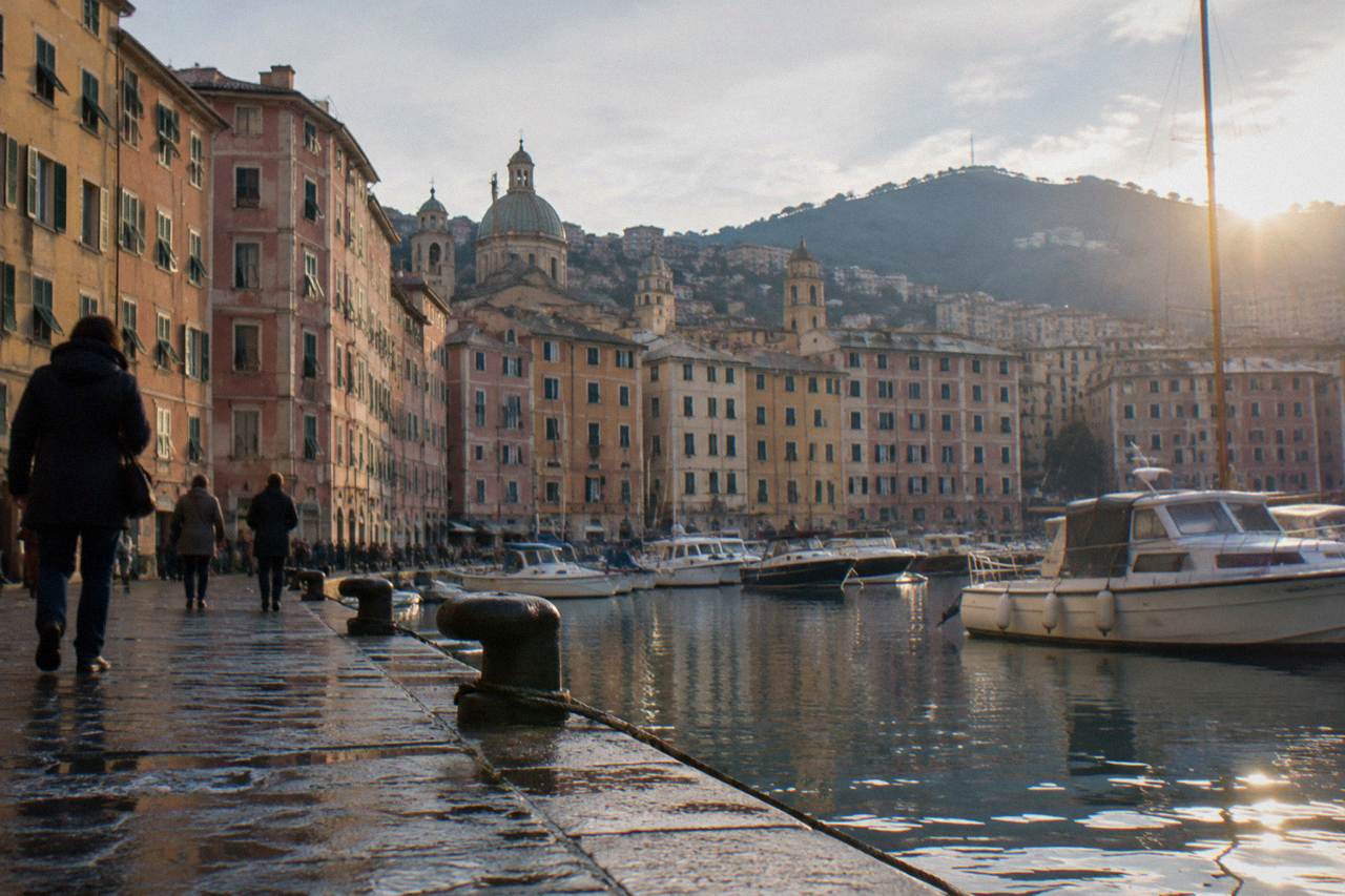 The old harbour of Genoa on a clear winter afternoon with boats moored along the water