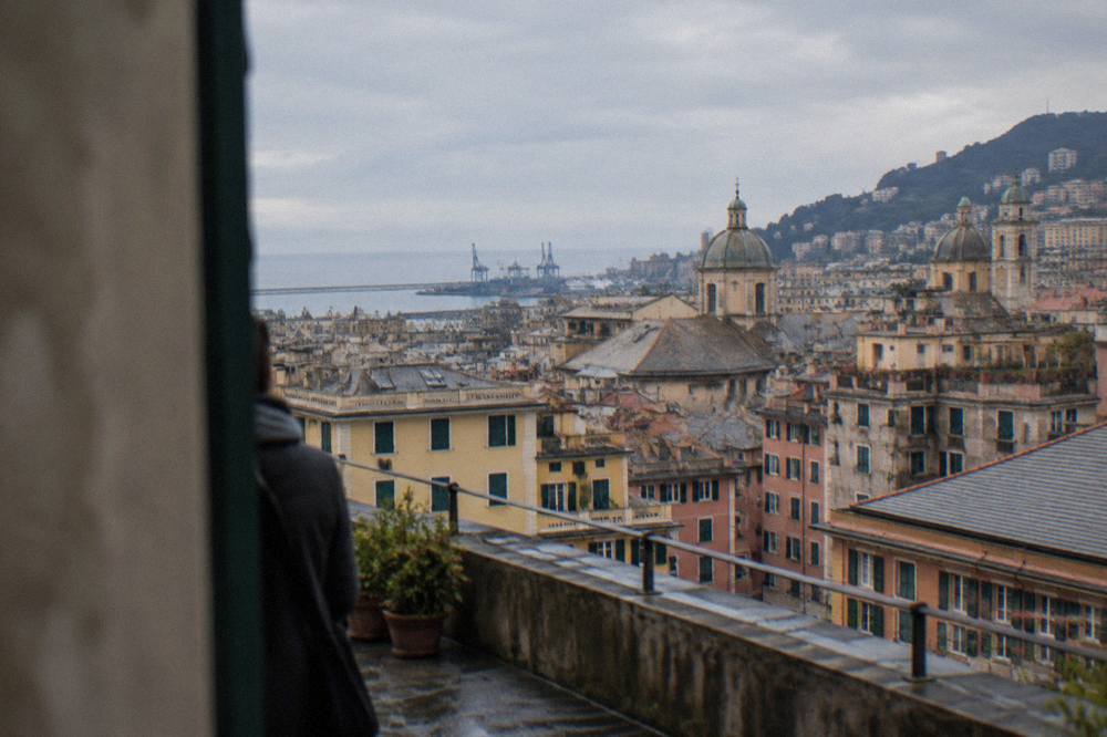 View over the rooftops of Genoa toward the sea from an upper terrace on a winter day
