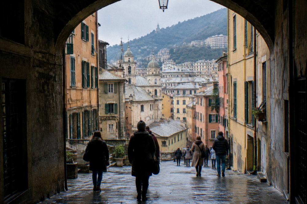 People walking through an arched medieval street in Genoa wearing winter coats