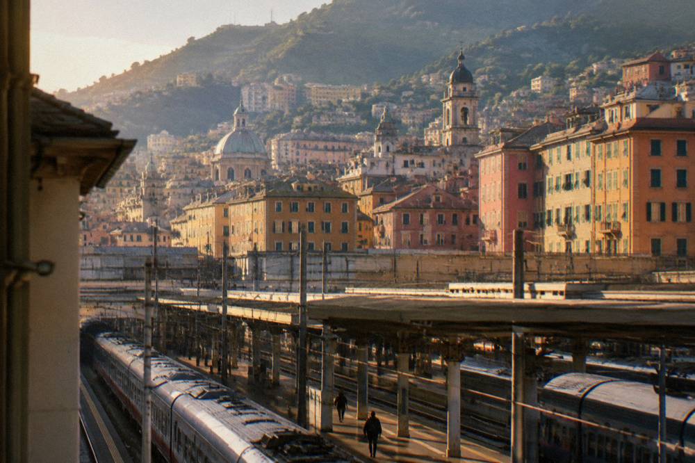 Railway platforms at a Genoa train station with trains under the station roof