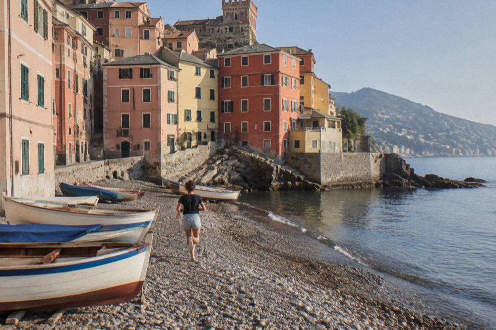 Colourful houses of the Boccadasse fishing village around a small pebble beach