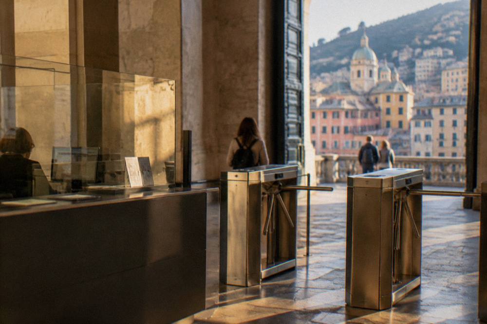Ticket counter and turnstiles at a museum entrance in Genoa