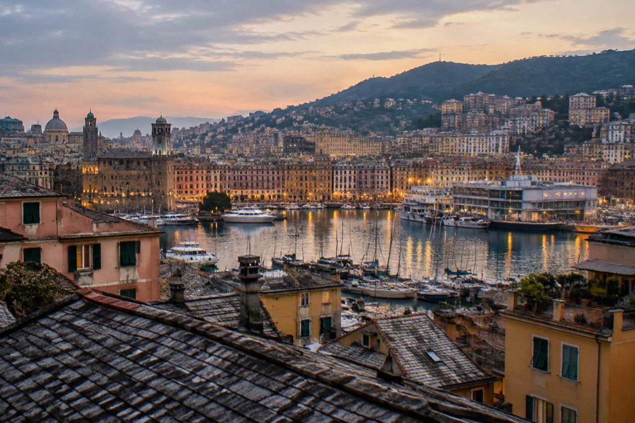 Evening view over the illuminated old harbour of Genoa with boats and city lights