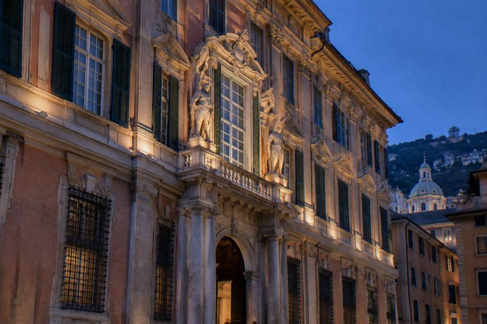 Lit facade of a Genoa museum palace at blue hour