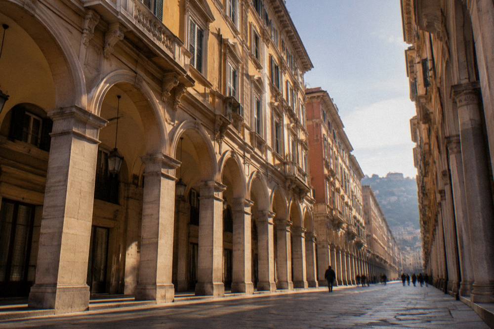 A grand Renaissance palace street with ornate facades and a stone pavement