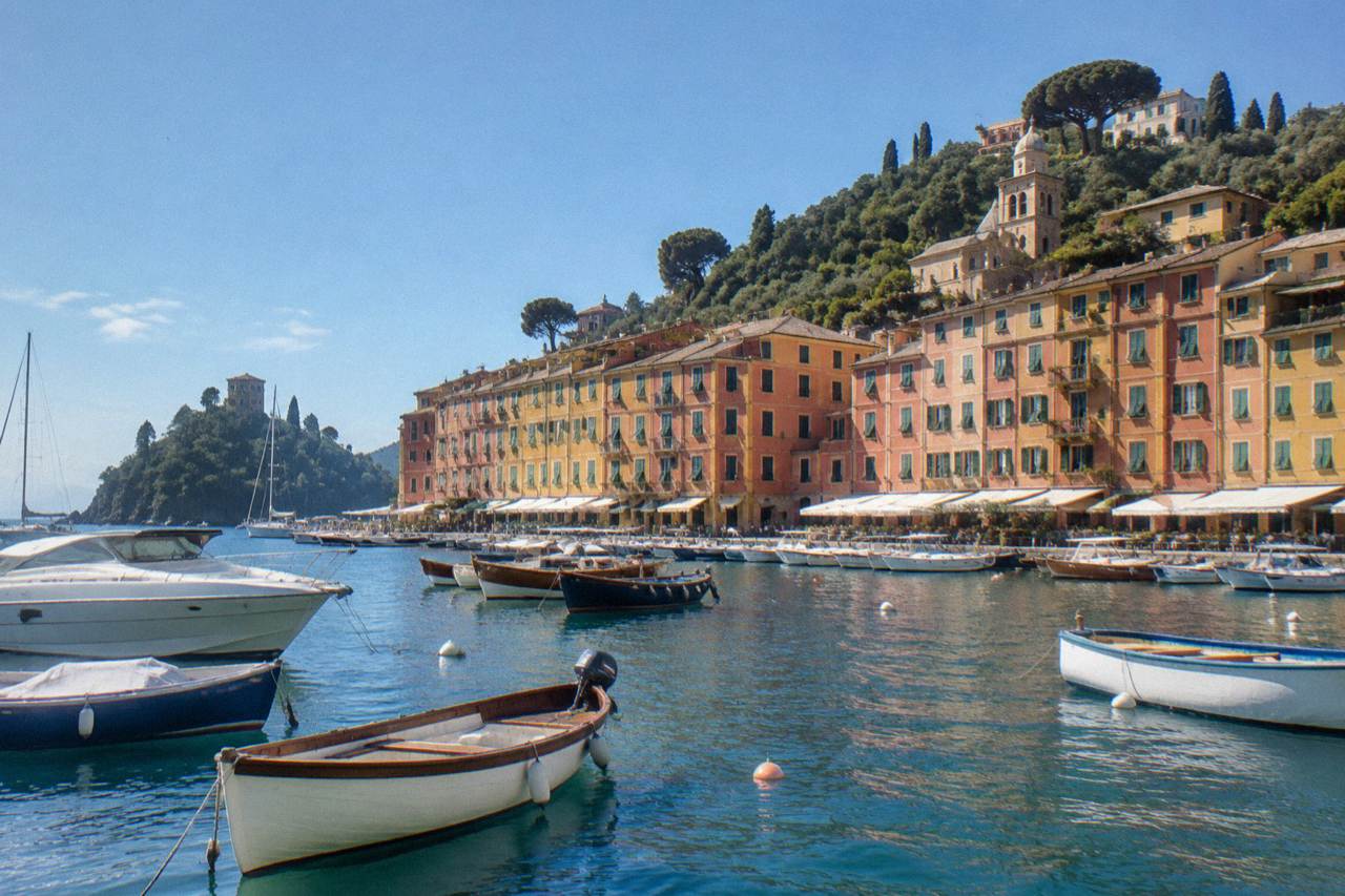 Colourful houses above a small harbour with fishing boats in Portofino