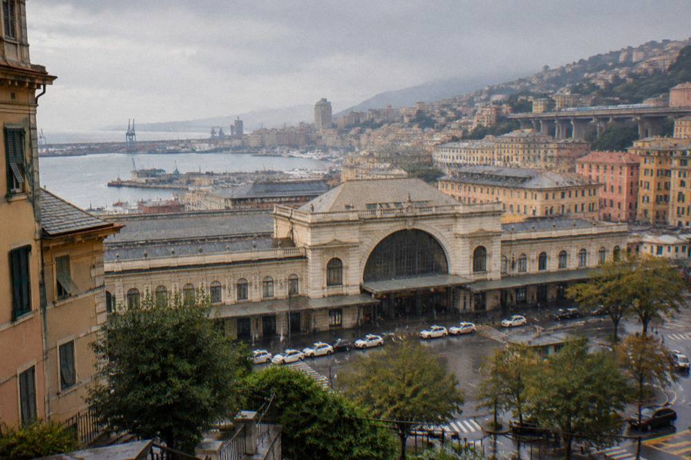 A view over Genoa's rooftops and harbour with a train viaduct in the distance