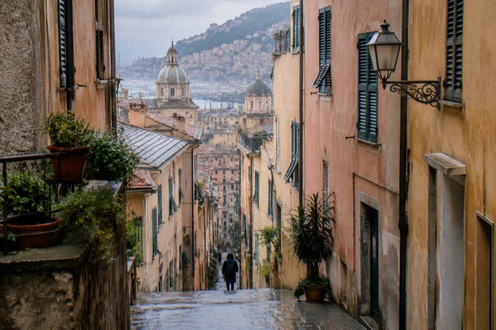 A narrow steep stone lane in the old town of Genoa after rain