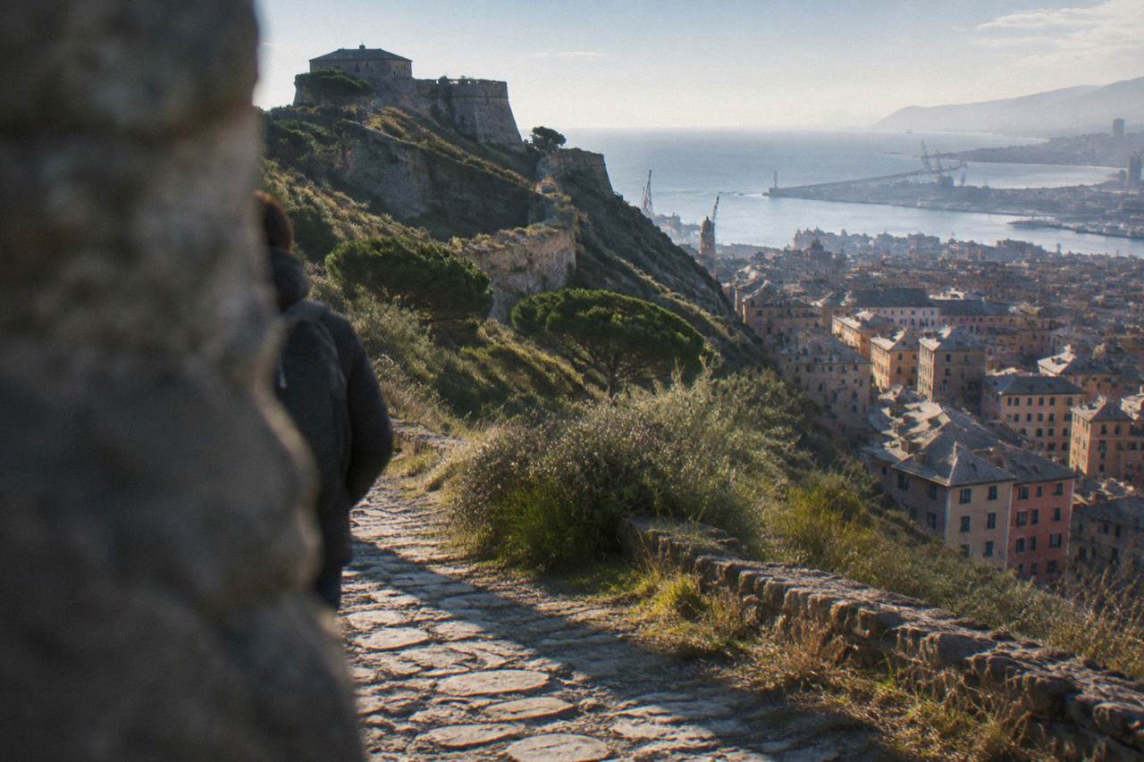 A stone footpath climbing through Mediterranean scrub above the Ligurian Sea