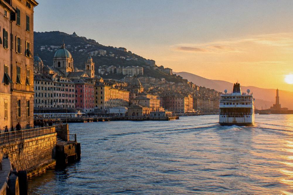 A ferry leaving the Genoa waterfront at sunset