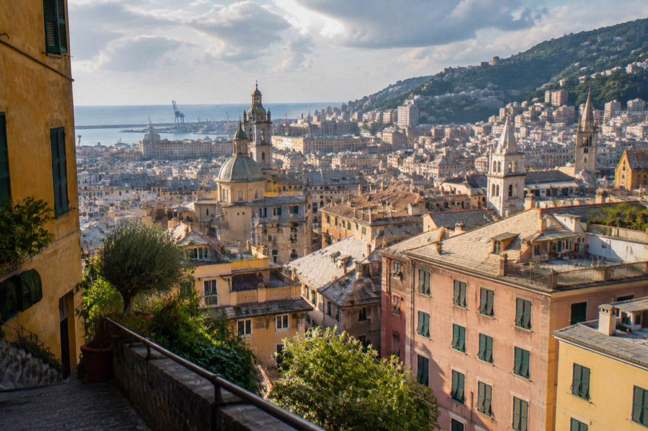 Rooftops and church towers of central Genoa seen from a hillside terrace