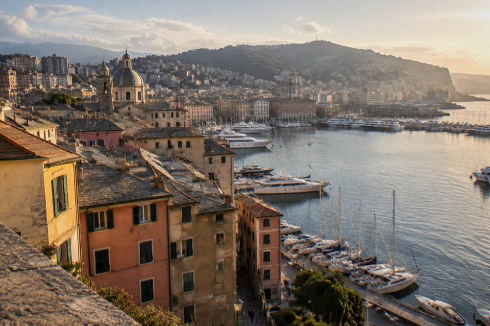 Evening light on the Genoa waterfront with boats moored along the harbour