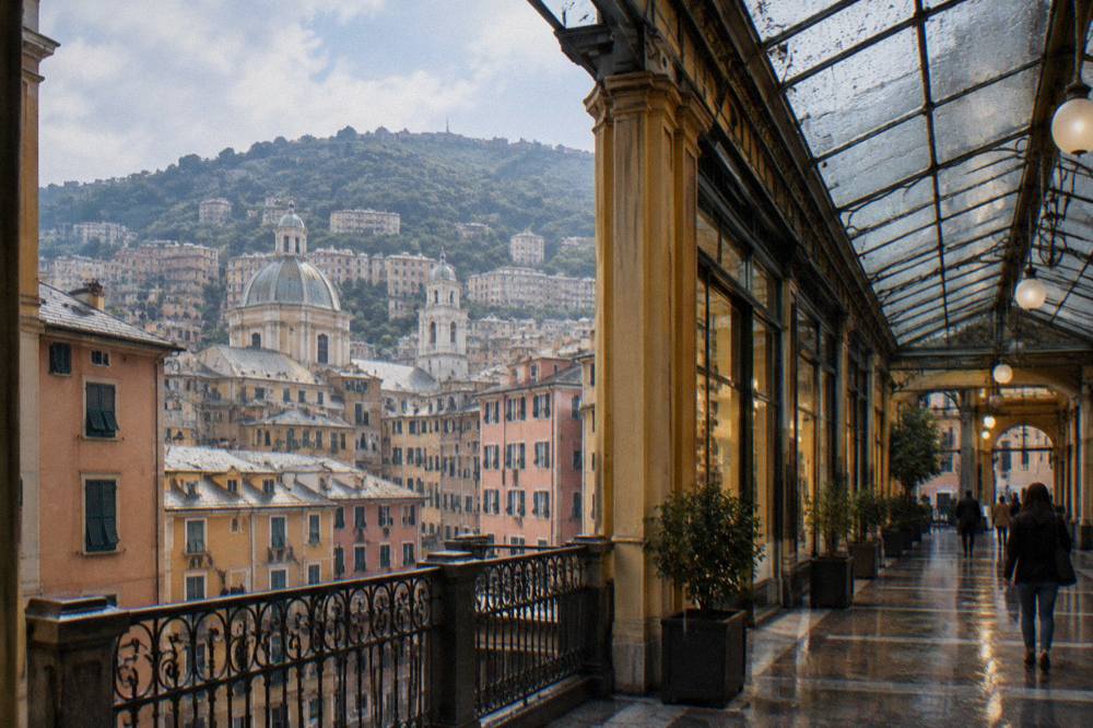 Rain streaking the glass roof of a covered shopping arcade in Genoa