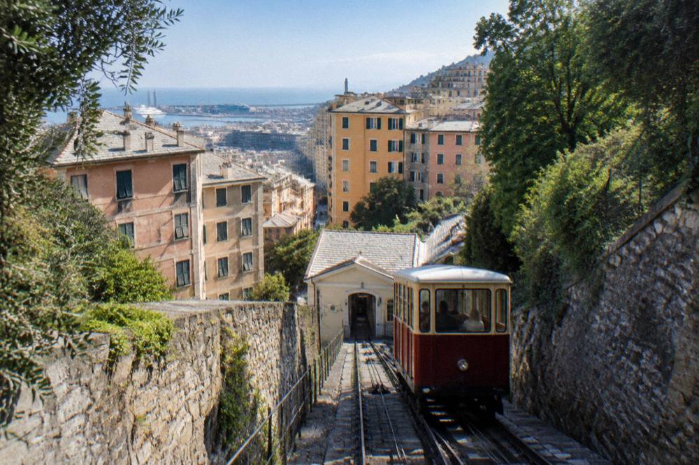 A funicular carriage climbing through Genoa's hillside streets