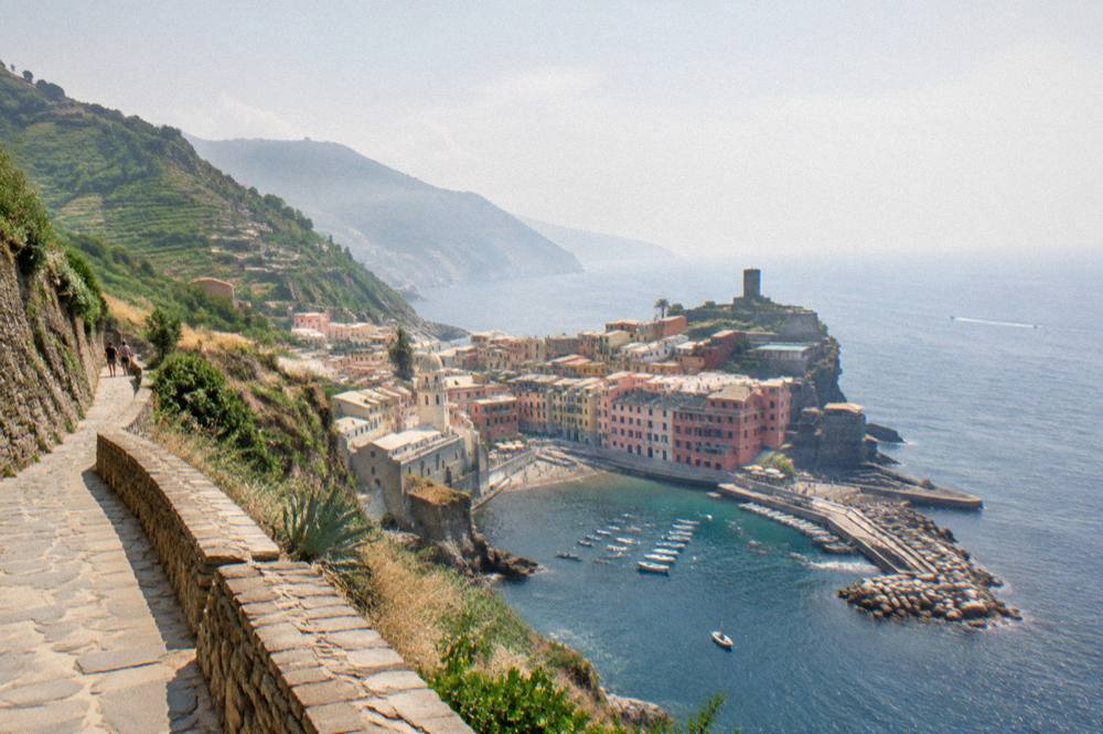 A stone footpath winding along a cliff edge above the sea