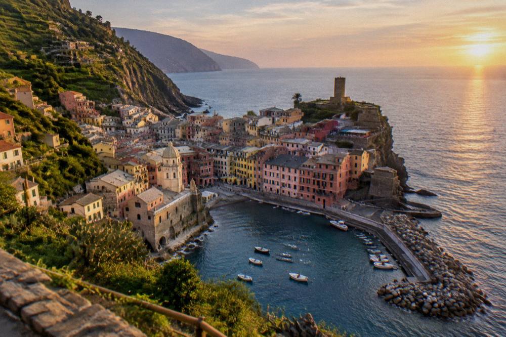 Sunset light on cliffside village rooftops above the Ligurian Sea