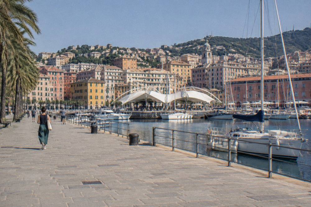 The Porto Antico waterfront in Genoa with moored boats and harbour buildings
